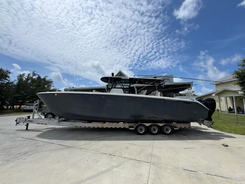 The Image of 2020 Invincible 40 Catamaran on trailer under a partly cloudy sky. - 1