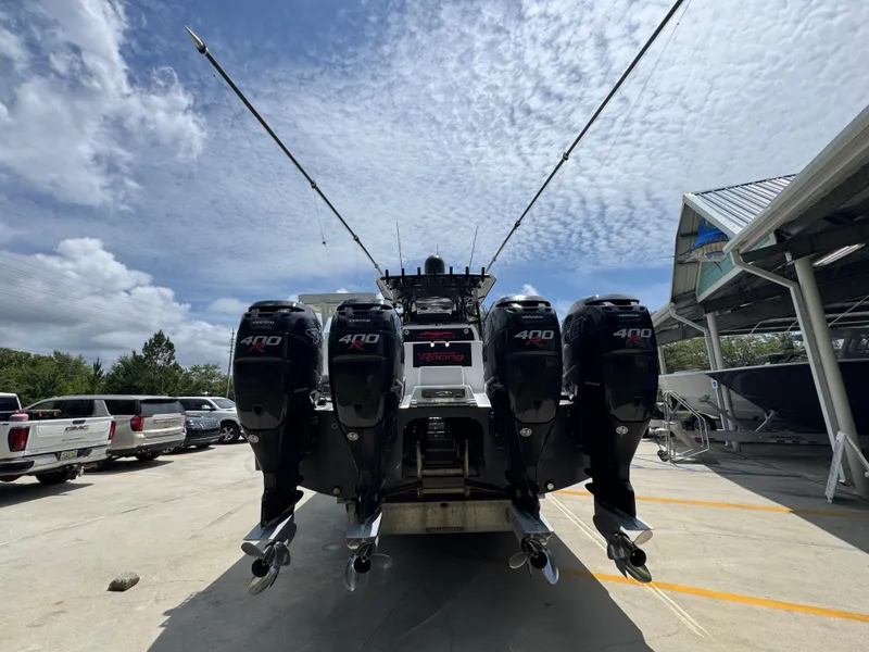 Slide: The Image of 2020 Invincible 40 Catamaran with four powerful 400 engines, docked under a partly cloudy sky. - 15