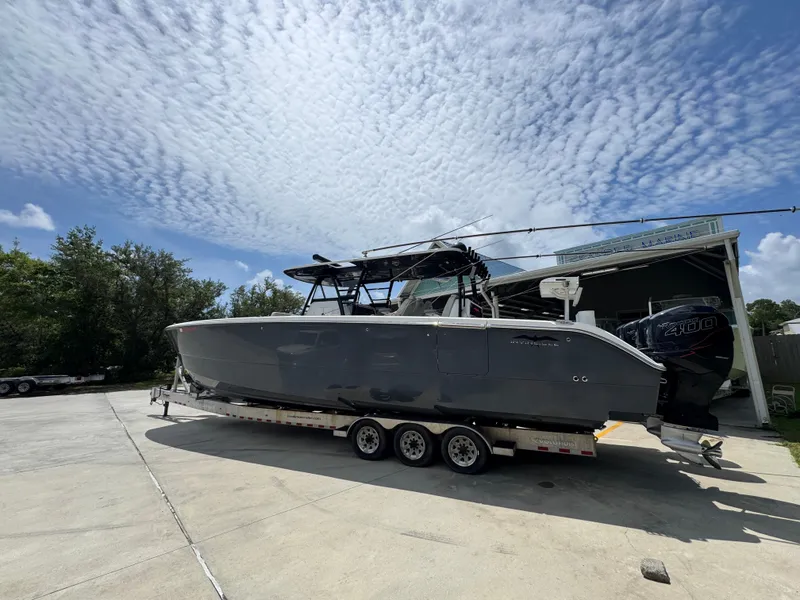 Slide: The Image of 2020 Invincible 40 Catamaran on trailer under cloudy sky. - 17
