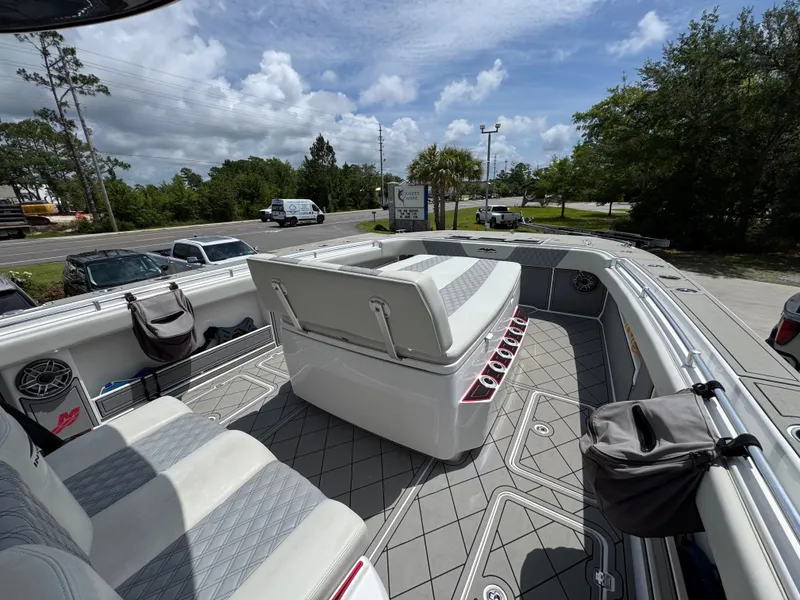 Slide: The Image of 2020 Invincible 40 Catamaran interior with seating, gray flooring, and outdoor view. - 19