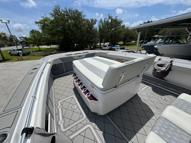 Slide: The Image of 2020 Invincible 40 Catamaran deck with seating, docked under a sunny sky. - 21