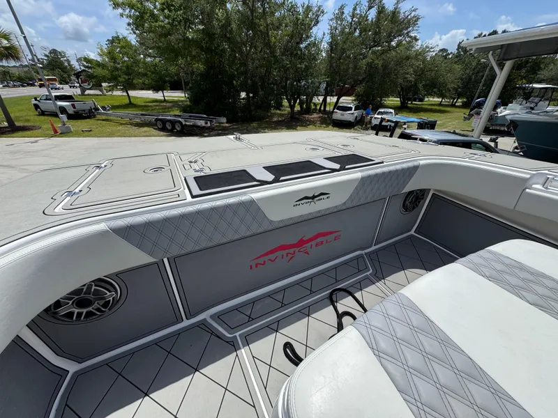 Slide: The Image of Invincible 40 Catamaran 2020 deck with seating and speaker, parked outdoors. - 22
