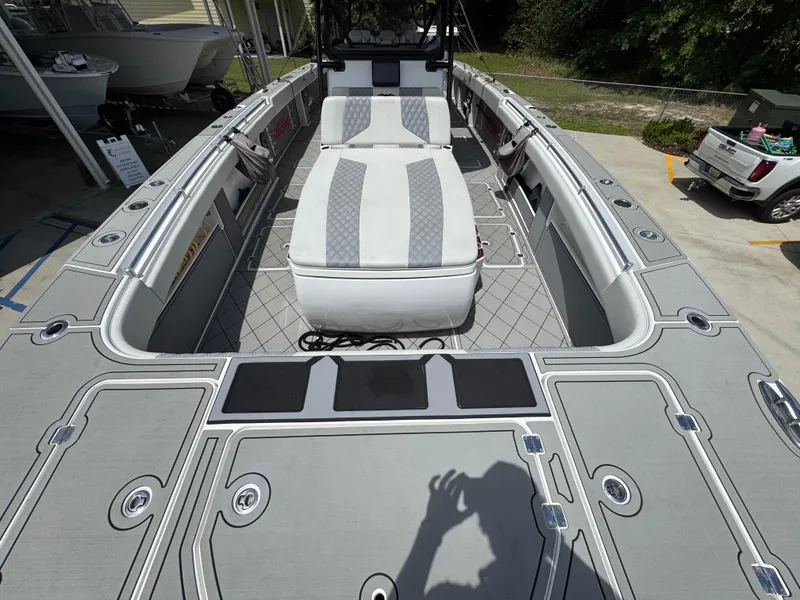 Slide: The Image of 2020 Invincible 40 Catamaran with spacious deck and seating, docked outdoors. - 23