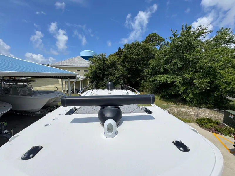 Slide: The Image of 2020 Invincible 40 Catamaran docked, showcasing sleek design and radar equipment under a clear sky. - 26