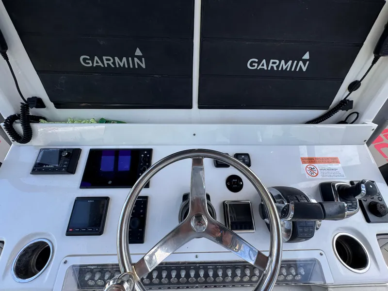 Slide: The Image of Cockpit of 2020 Invincible 40 Catamaran with Garmin navigation displays and steering wheel. - 35
