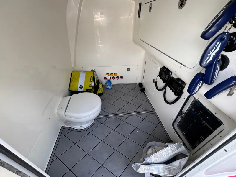 Slide: The Image of 2020 Invincible 40 Catamaran interior with toilet, safety gear, and control panel. - 36