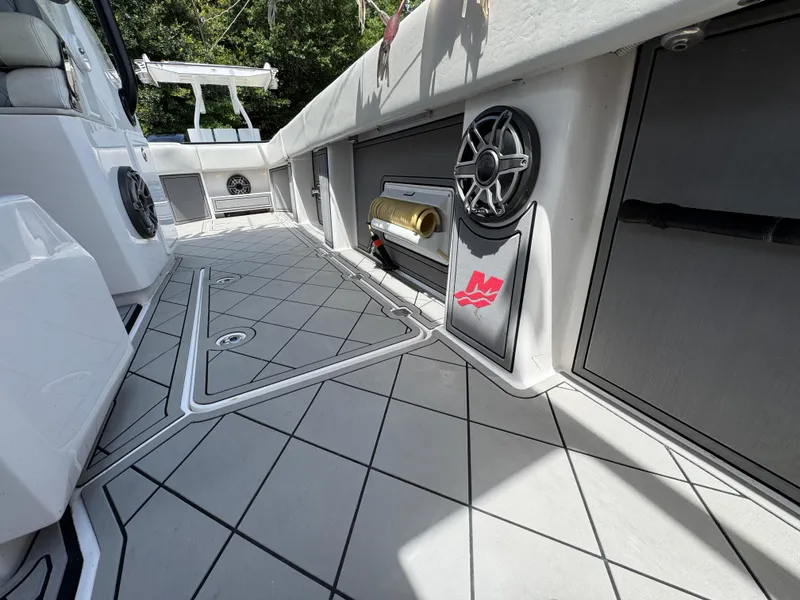 Slide: The Image of 2020 Invincible 40 Catamaran deck with modern design, featuring speakers and storage compartments. - 38