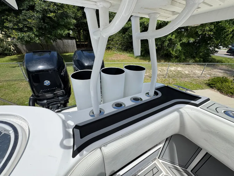 Slide: The Image of 2020 Invincible 40 Catamaran with rod holders and dual outboard motors. - 47