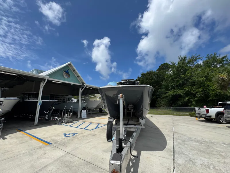 Slide: The Image of 2020 Invincible 40 Catamaran on trailer, parked outside under a clear blue sky. - 6