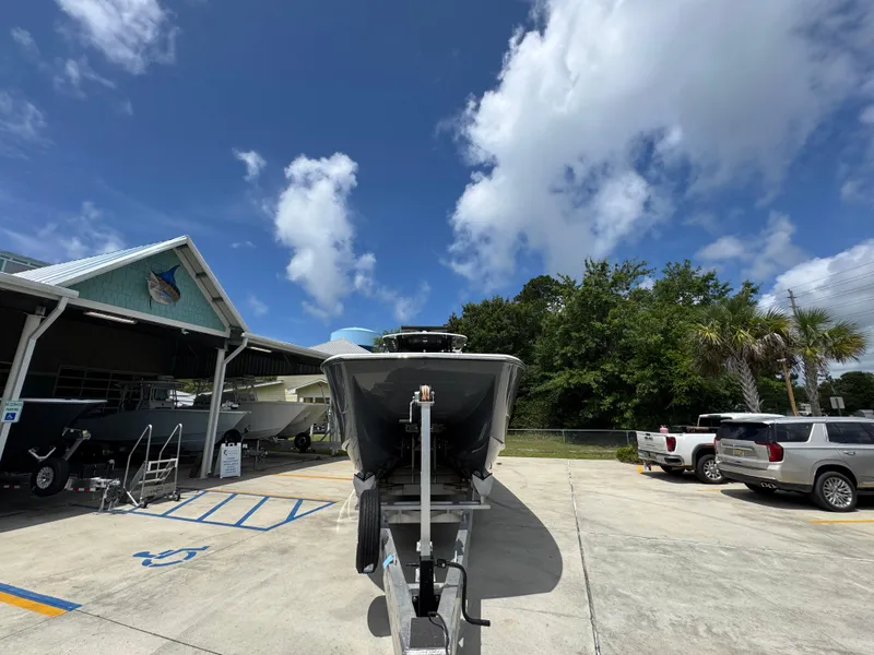 Slide: The Image of 2020 Invincible 40 Catamaran on trailer under a clear blue sky. - 7