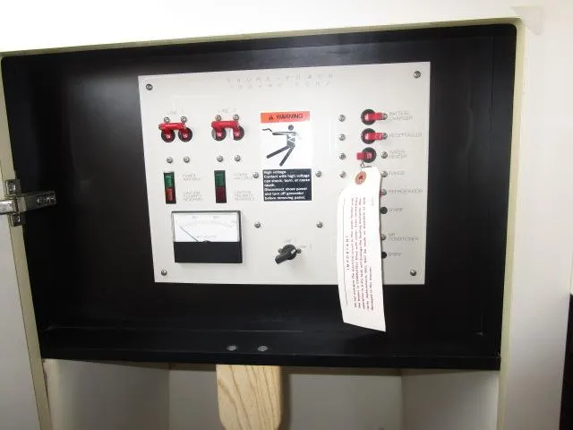 Slide: The Image of Control panel of a 1999 Maxum 2800SCR boat with switches and warning label. - 14
