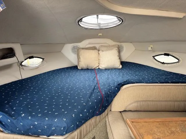 Slide: The Image of Interior cabin of 1999 Maxum 2800SCR boat with cozy bed and porthole windows. - 18