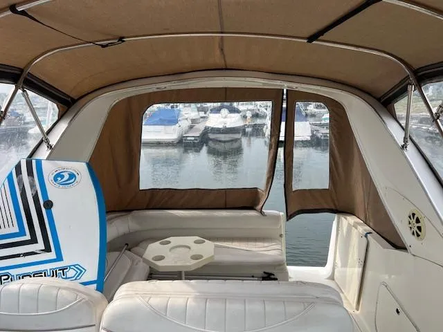 Slide: The Image of Interior view of 1999 Maxum 2800SCR boat with seating and marina backdrop. - 20