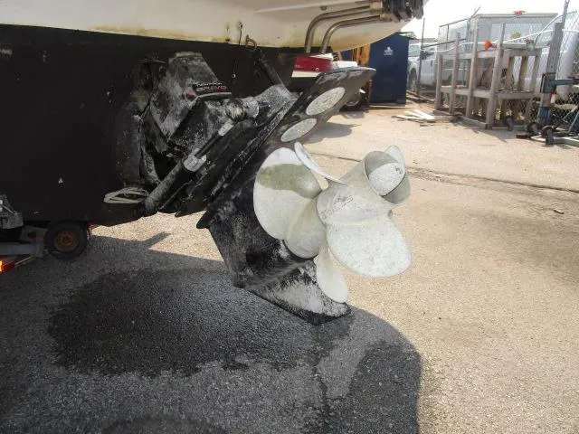 Slide: The Image of 1999 Maxum 2800SCR boat propeller and stern drive in a marina setting. - 22