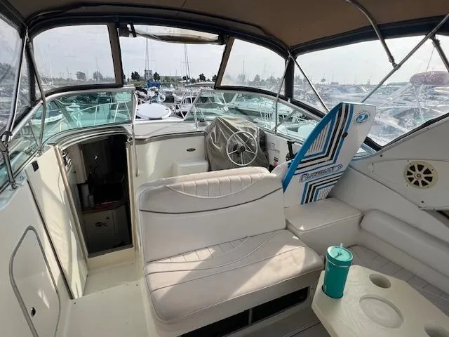 Slide: The Image of 1999 Maxum 2800SCR boat interior with seating, steering wheel, and cup holder. - 5