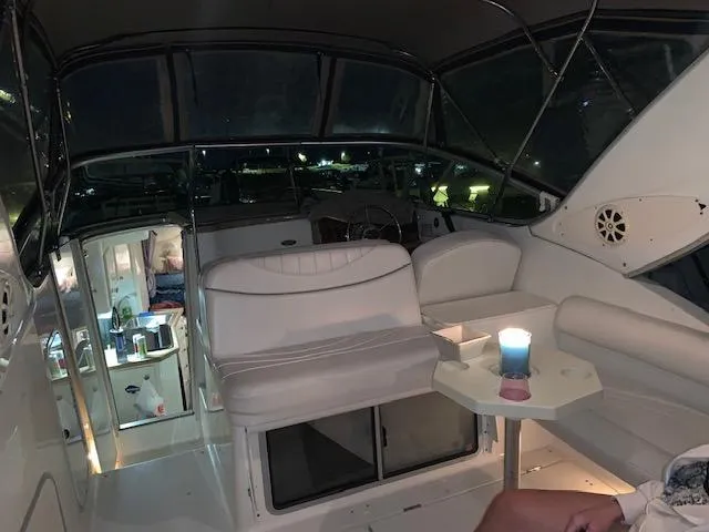 Slide: The Image of Interior of a 1999 Maxum 2800SCR boat with white seating and ambient lighting. - 6