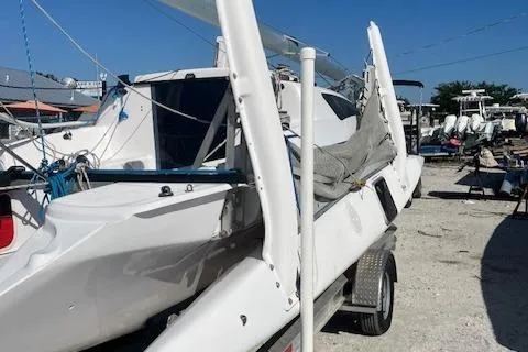 Slide: The Image of 2012 Corsair Dash 750 sailboat on trailer, white hull, parked outdoors. - 1
