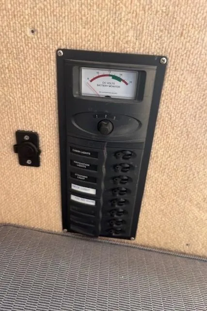 Slide: The Image of Control panel of a 2012 Corsair Dash 750 sailboat with voltage meter and switches. - 6