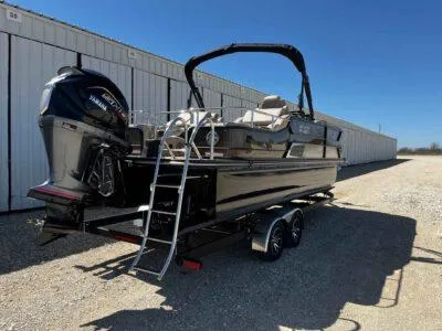 Slide: The Image of 2025 SunCatcher Elite 324 SS pontoon boat on trailer, parked outdoors. - 7