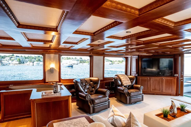 Slide: The Image of Luxurious 1993 Queenship LRC yacht interior with leather chairs, wood paneling, and waterfront view. - 15