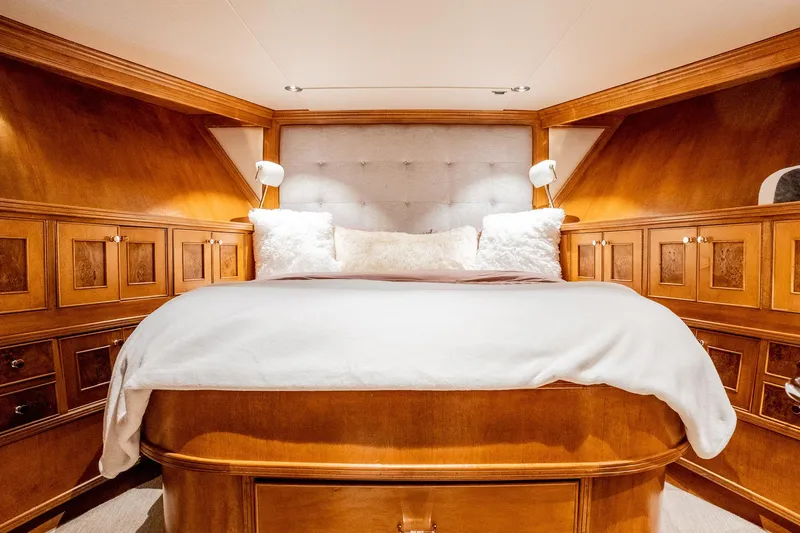 Slide: The Image of Luxurious 1993 Queenship LRC yacht bedroom with elegant wood paneling and plush bedding. - 17