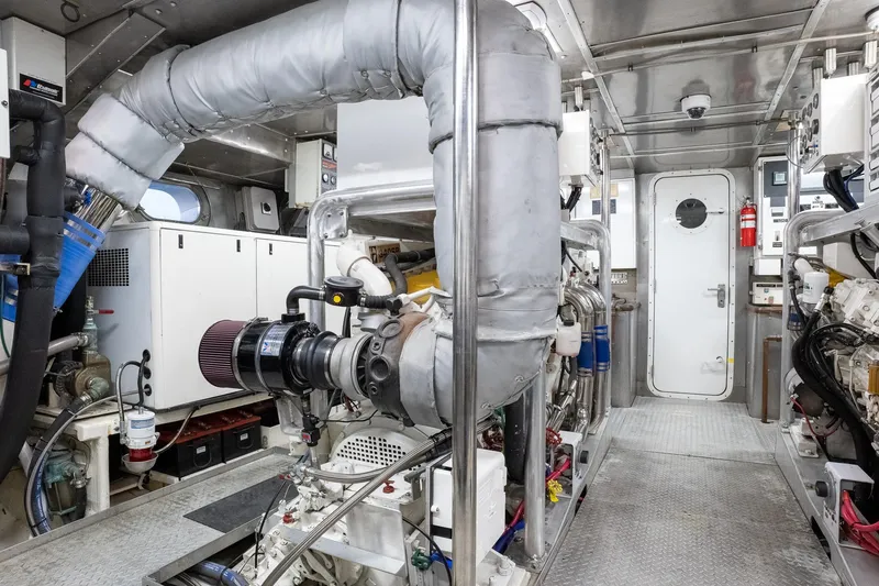 Slide: The Image of Engine room of a 1993 Queenship LRC yacht, featuring machinery and equipment. - 25