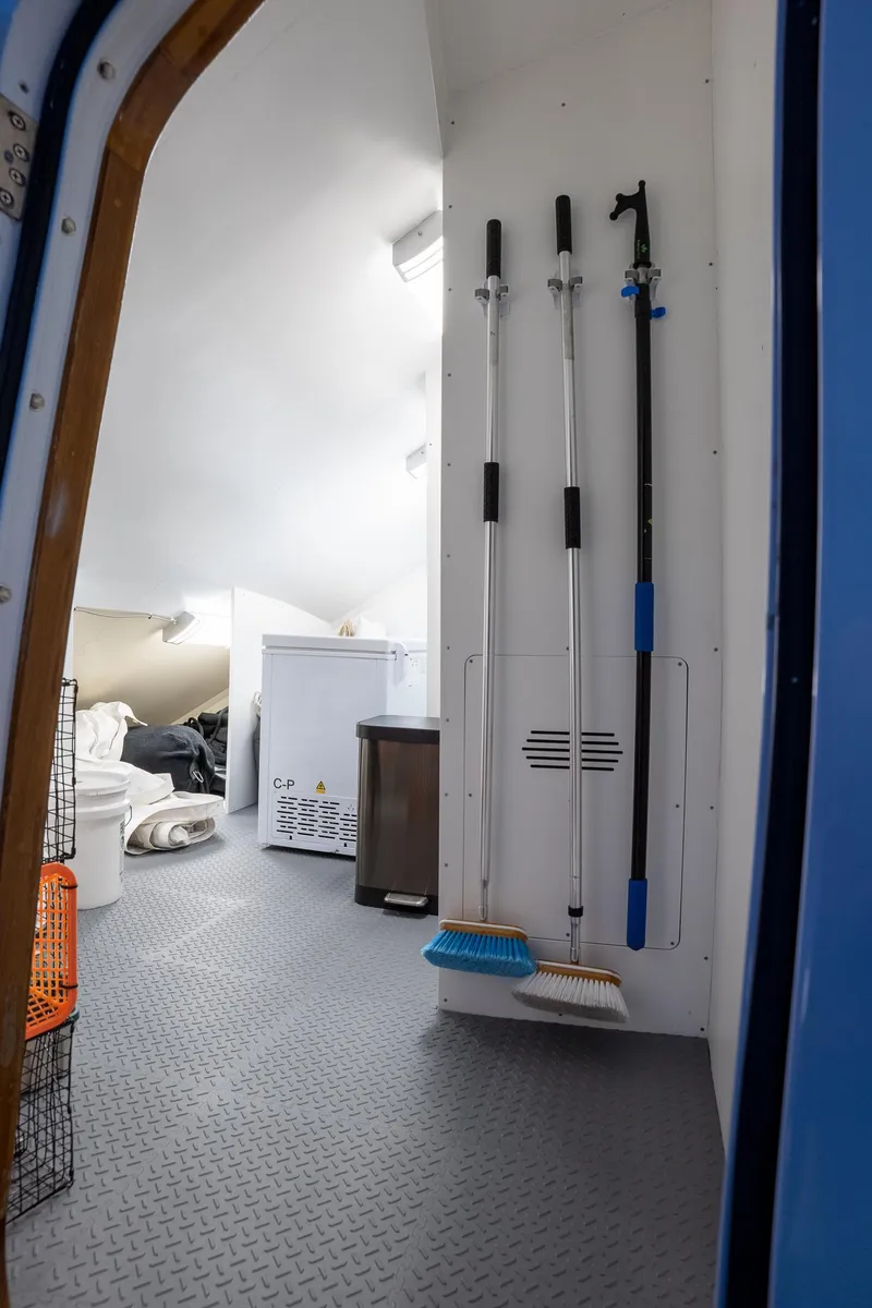 Slide: The Image of Interior of 1993 Queenship LRC boat with cleaning tools and storage area. - 29