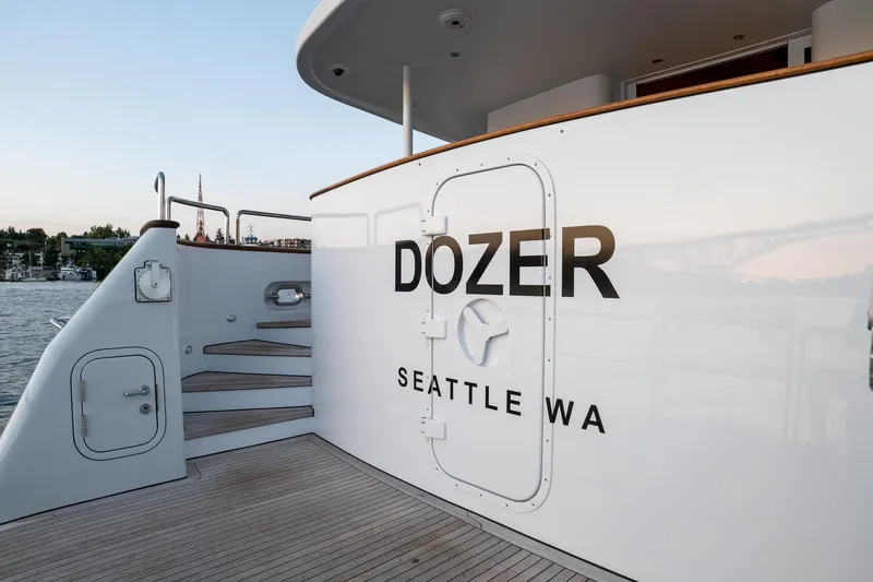 Slide: The Image of Queenship LRC 1993 yacht "Dozer" docked in Seattle, featuring sleek white exterior. - 3