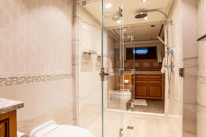 Slide: The Image of Luxurious 1993 Queenship LRC yacht bathroom with glass shower and elegant wood cabinetry. - 30