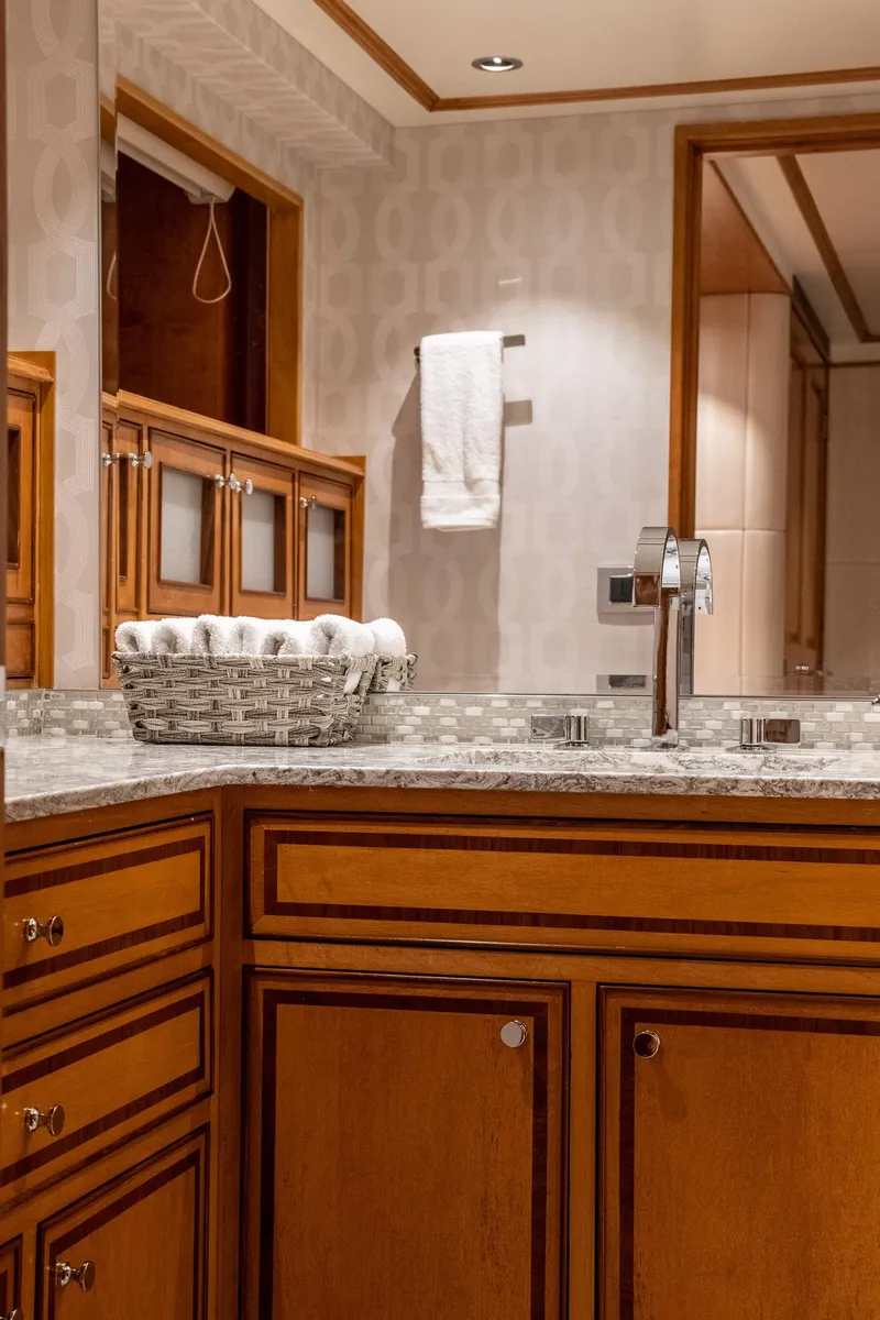 Slide: The Image of Luxurious bathroom interior on a 1993 Queenship LRC yacht, featuring wooden cabinetry and elegant fixtures. - 32