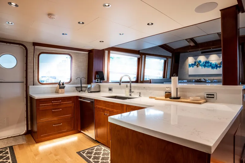 Slide: The Image of Luxurious 1993 Queenship LRC yacht kitchen with modern wood cabinetry and sleek countertops. - 34