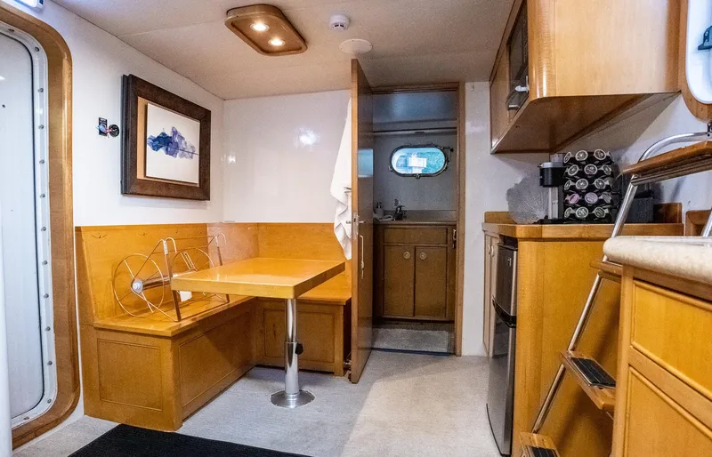 Slide: The Image of Interior of 1993 Queenship LRC yacht with dining area and kitchenette. - 41