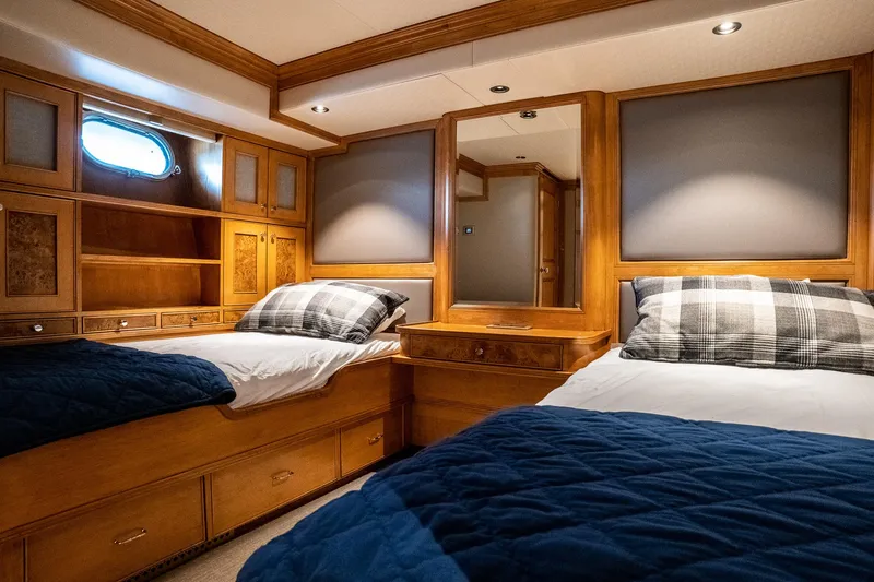 Slide: The Image of Luxurious 1993 Queenship LRC yacht cabin with twin beds, wooden furnishings, and nautical decor. - 47