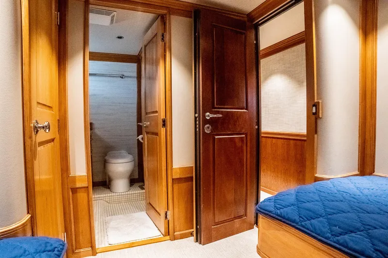 Slide: The Image of Luxurious 1993 Queenship LRC yacht interior with wooden doors, cozy cabin, and modern bathroom. - 48