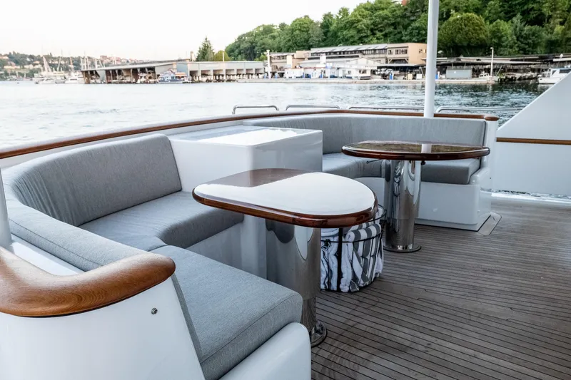 Slide: The Image of Luxurious 1993 Queenship LRC yacht deck with elegant seating and scenic waterfront view. - 6