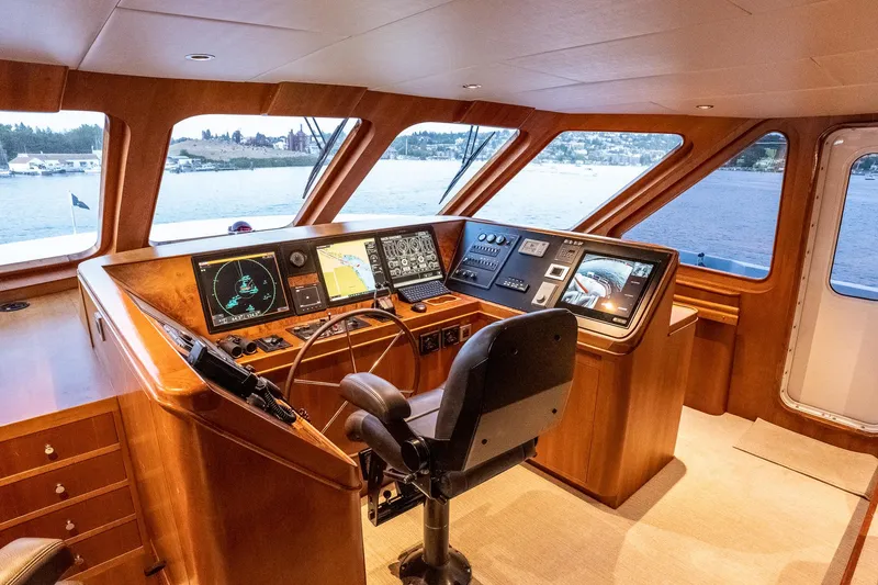 Slide: The Image of Cockpit of 1993 Queenship LRC yacht with navigation equipment and panoramic windows. - 8