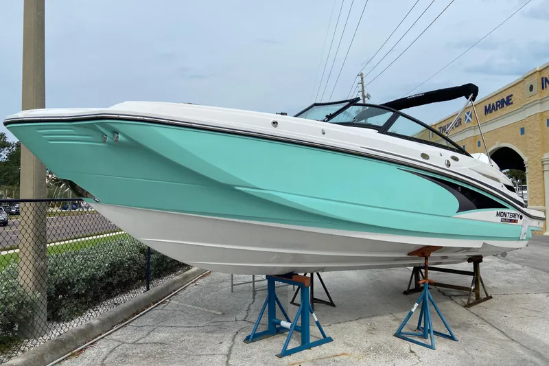 The Image of 2025 Monterey M-45 boat in mint green on stands at a marina. - 0