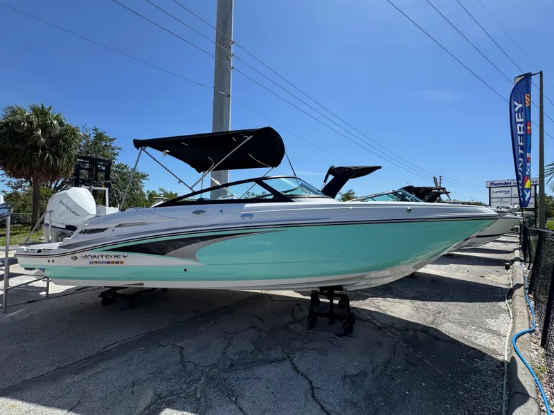 The Image of 2025 Monterey M-45 boat with canopy on display under clear blue sky. - 1