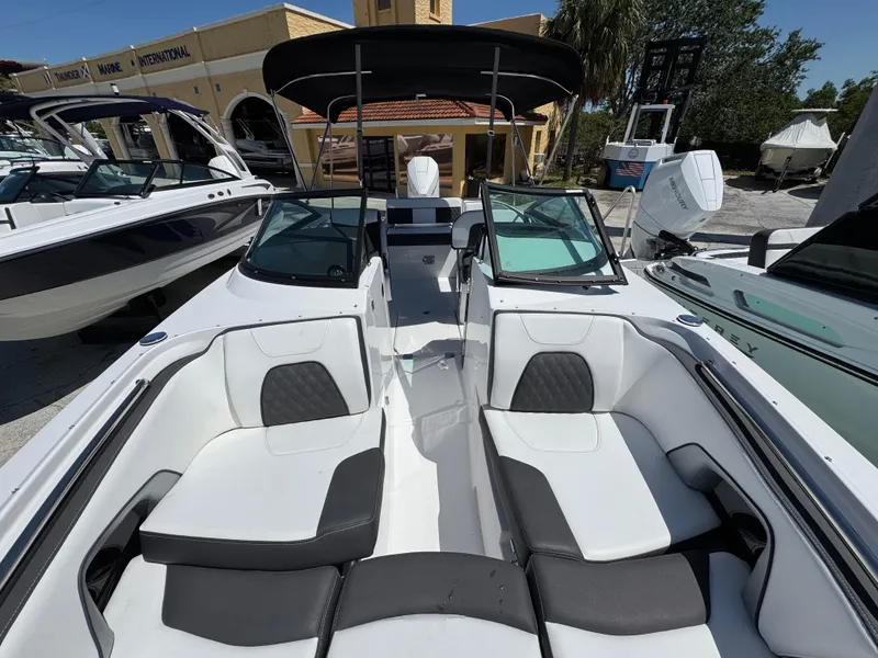 Slide: The Image of 2025 Monterey M-45 boat with sleek white and black seating, docked at a marina. - 15