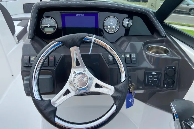 Slide: The Image of Steering wheel and dashboard of 2025 Monterey M-45 boat with control panel and gauges. - 17