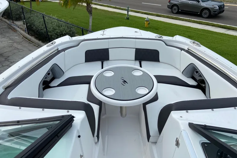 Slide: The Image of 2025 Monterey M-45 boat interior with circular table and cushioned seating. - 27