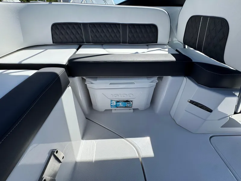 Slide: The Image of 2025 Monterey M-45 boat interior with cushioned seating and built-in cooler. - 5