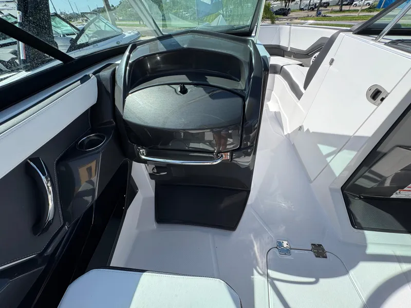 Slide: The Image of 2025 Monterey 255SS boat interior with sleek black and white design. - 13