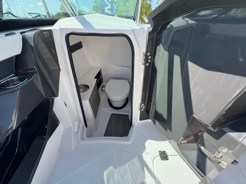 Slide: The Image of 2025 Monterey 255SS boat interior with compact bathroom and toilet. - 14