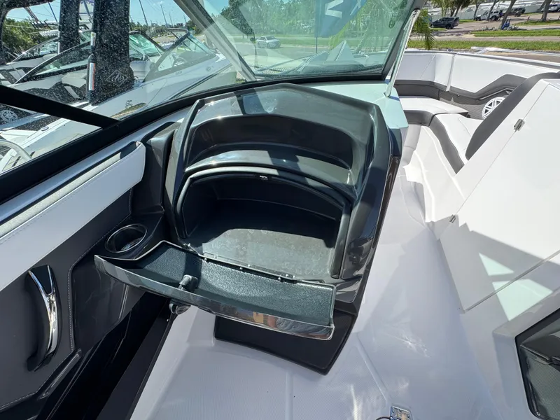 Slide: The Image of Interior view of 2025 Monterey 255SS boat with open storage compartment. - 15