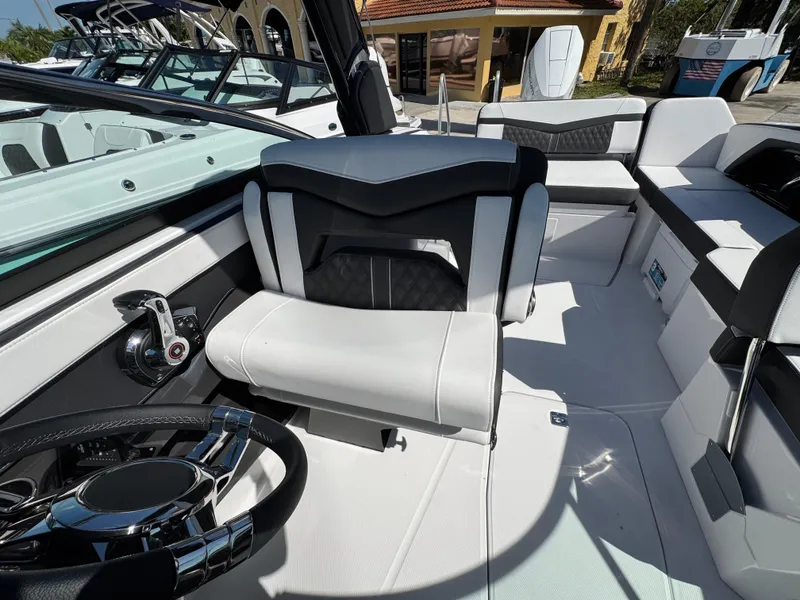 Slide: The Image of Interior of 2025 Monterey 255SS boat with modern seating and steering wheel. - 17