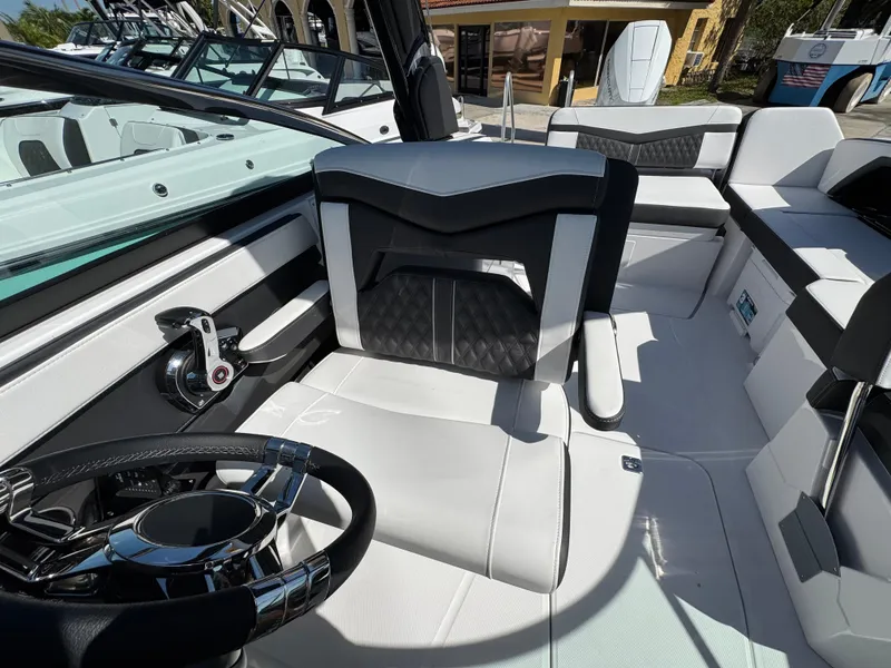 Slide: The Image of 2025 Monterey 255SS boat interior with sleek black and white seating and modern steering wheel. - 18