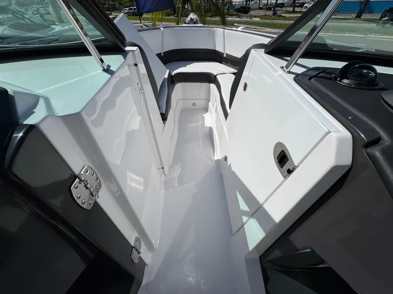 Slide: The Image of 2025 Monterey 255SS boat interior with sleek white design and modern features. - 19