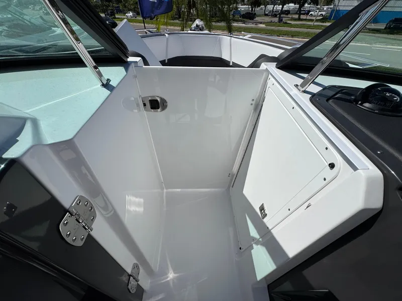 Slide: The Image of 2025 Monterey 255SS boat interior with open storage compartment and sleek design. - 20