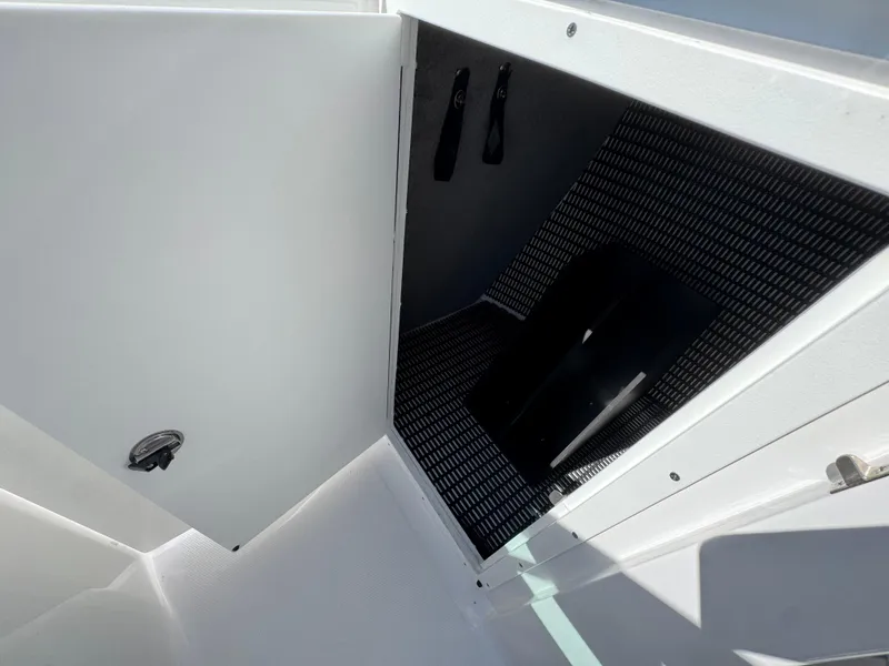 Slide: The Image of Open storage compartment in 2025 Monterey 255SS boat, featuring sleek interior design. - 21